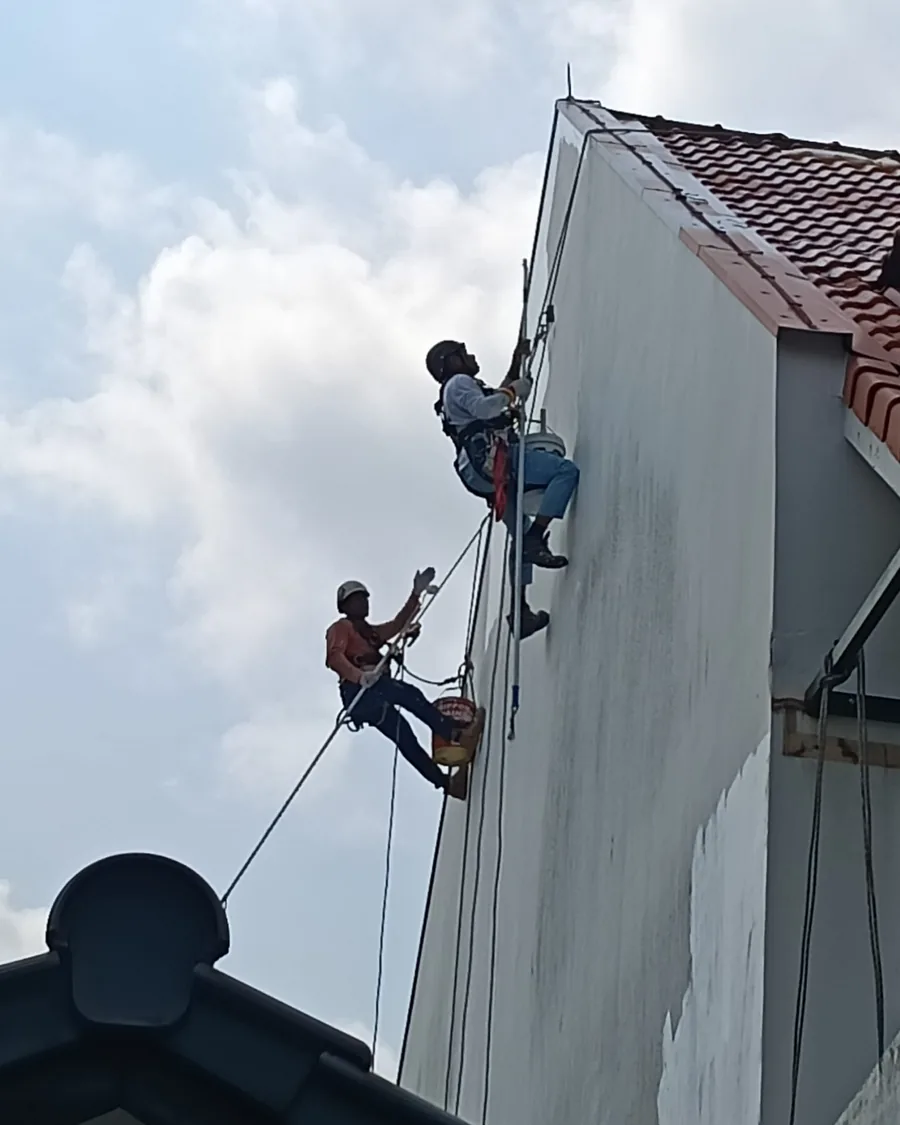 Two City Painters abseilers working down an exterior wall on a Singapore building