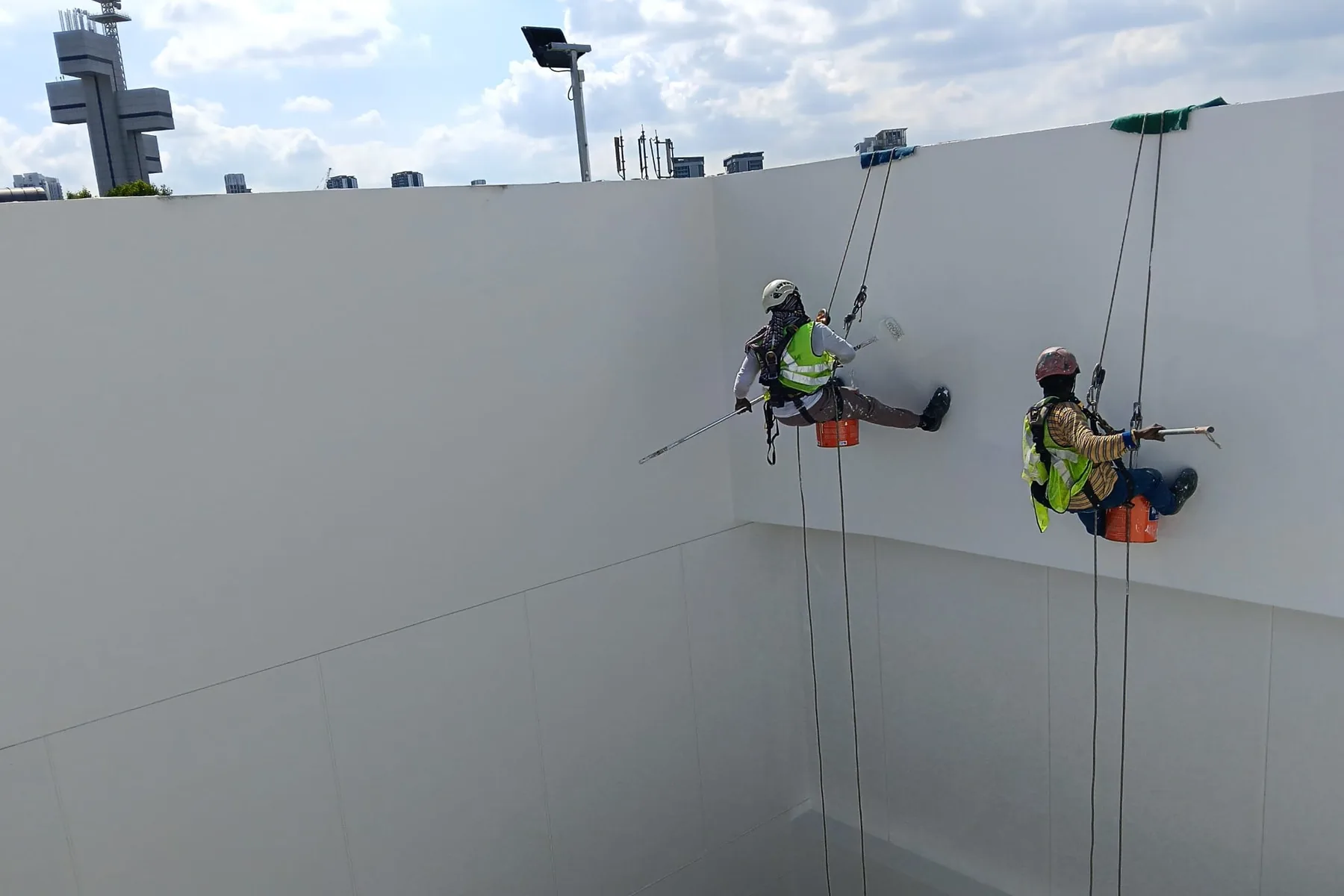 City Painters rope-access crew painting a multi-storey facade in Singapore