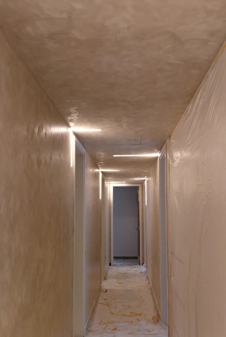Limewash finish carried along a Singapore home corridor
