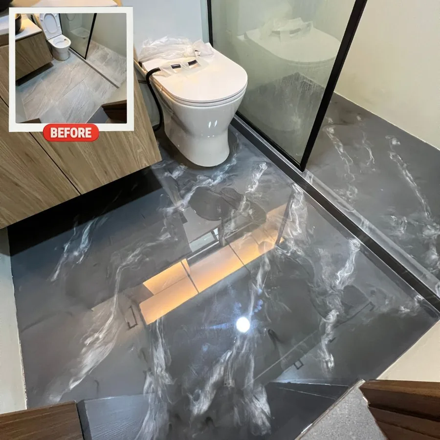 Black and white metallic epoxy floor beside a glass shower screen