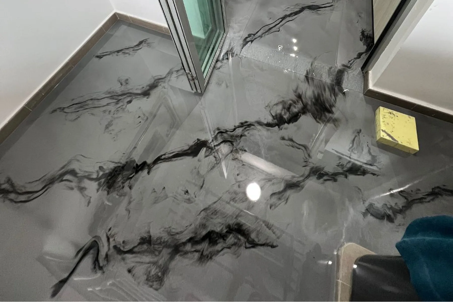 Grey marble-effect metallic epoxy resin floor installed by City Painters in a Singapore home